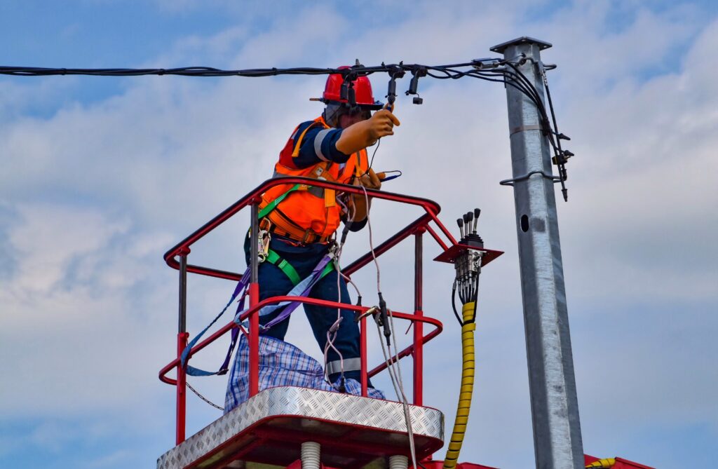 Utility worker maintaining transmission line